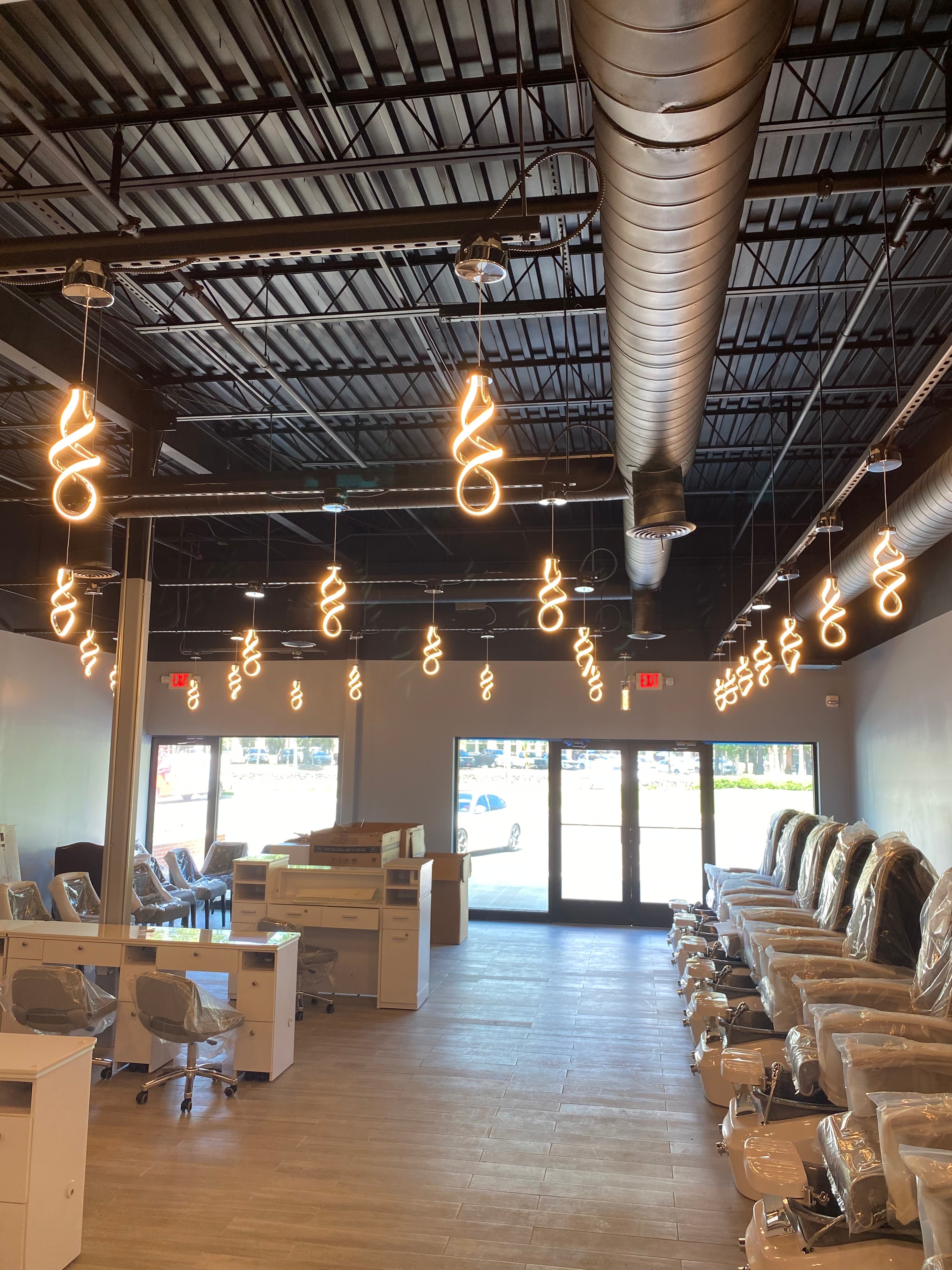 Completed commercial lighting installation with decorative pendant fixtures